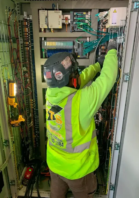 Technician working on an electrical panel